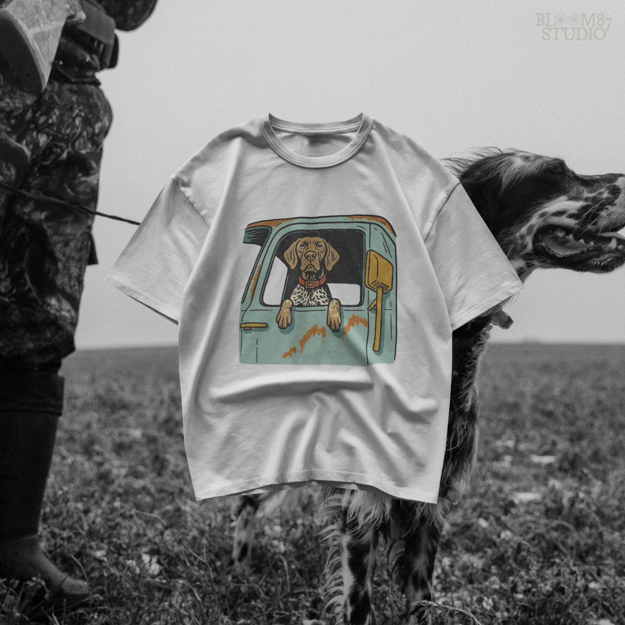 Vintage-style German Shorthaired Pointer with front paws out an old farm truck window – rustic hunting dog sublimation PNG.