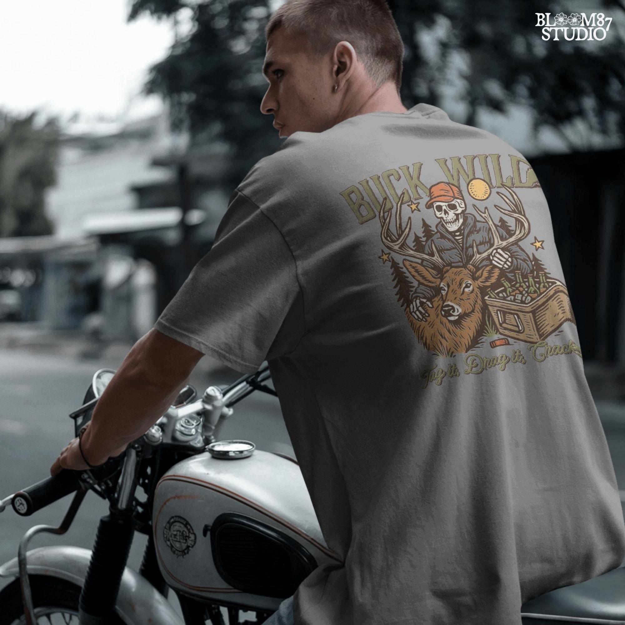 A funny deer hunting illustration with a skeleton hunter holding a buck and cooler of beer under the phrase “Tag it, Drag it, Crack it”.