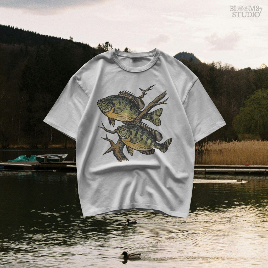 Two vintage-style bluegill fish swimming with underwater branches – realistic rustic PNG for sublimation shirts, signs, and fishing gifts.