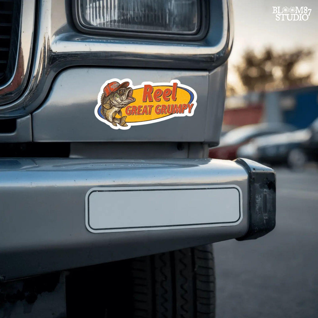 Retro-style grumpy bass fish wearing a red outdoor hat with bold text “Reel Great Grumpy” on a yellow and orange background