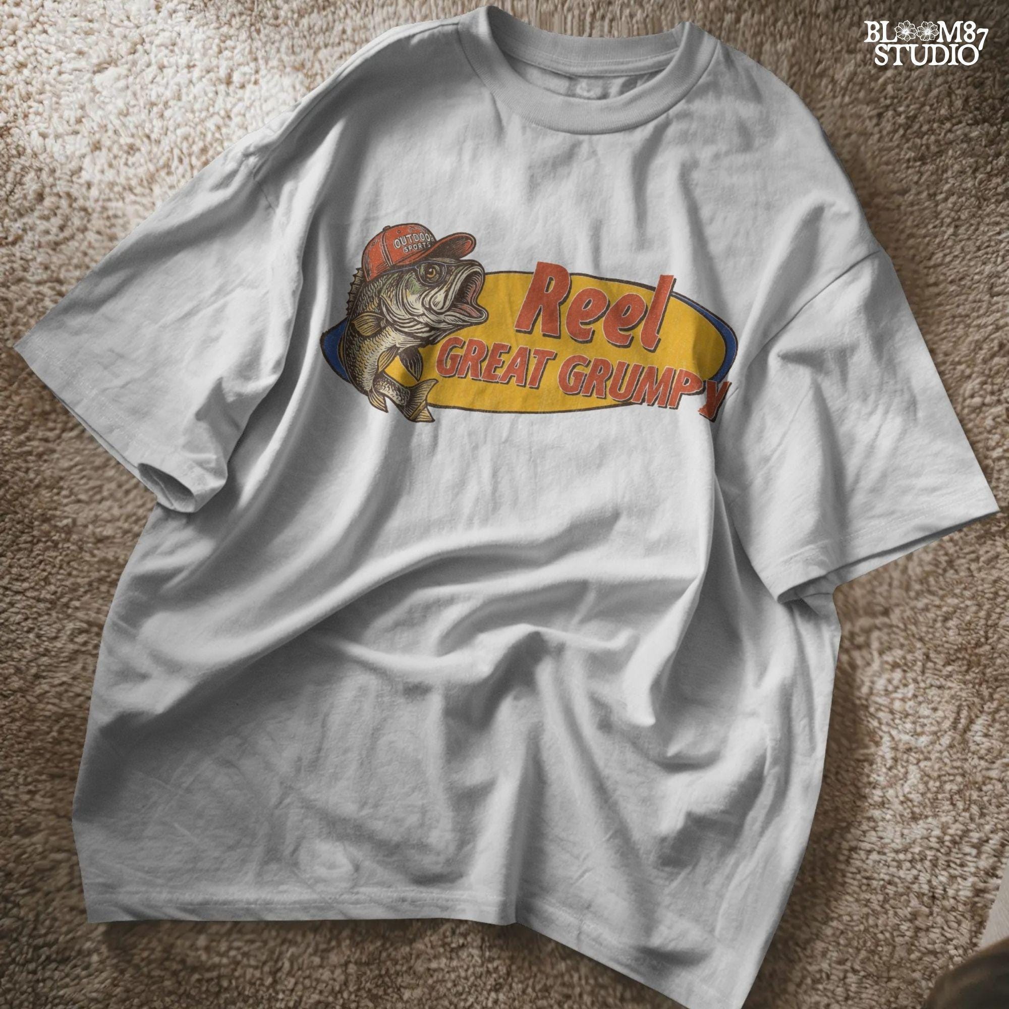 Retro-style grumpy bass fish wearing a red outdoor hat with bold text “Reel Great Grumpy” on a yellow and orange background