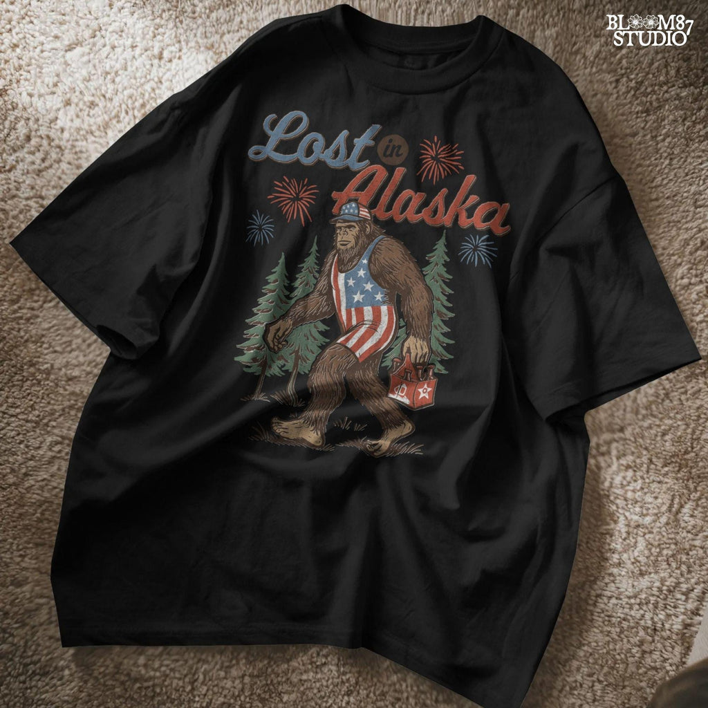Bigfoot wearing an American flag outfit and cap, walking through forest with fireworks in background, holding a six-pack of beer with “Lost in Alaska” text