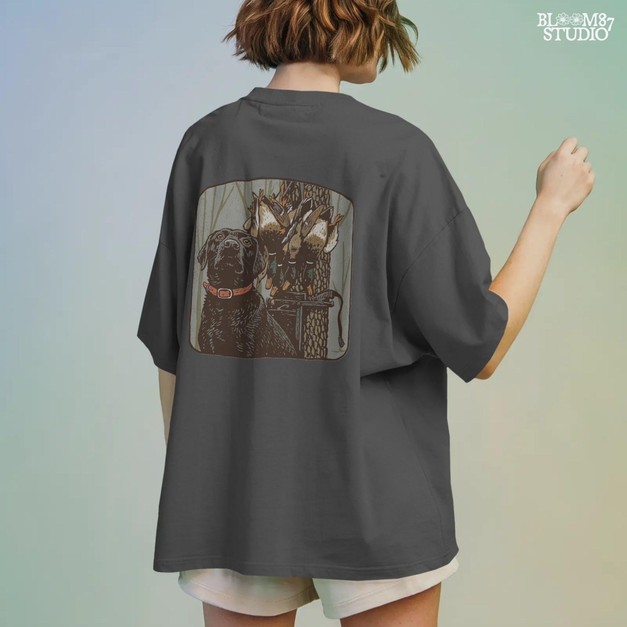 Digital PNG design of a black lab hunting dog with mallard ducks on a strap, ideal for sublimation printing on hunting-themed apparel