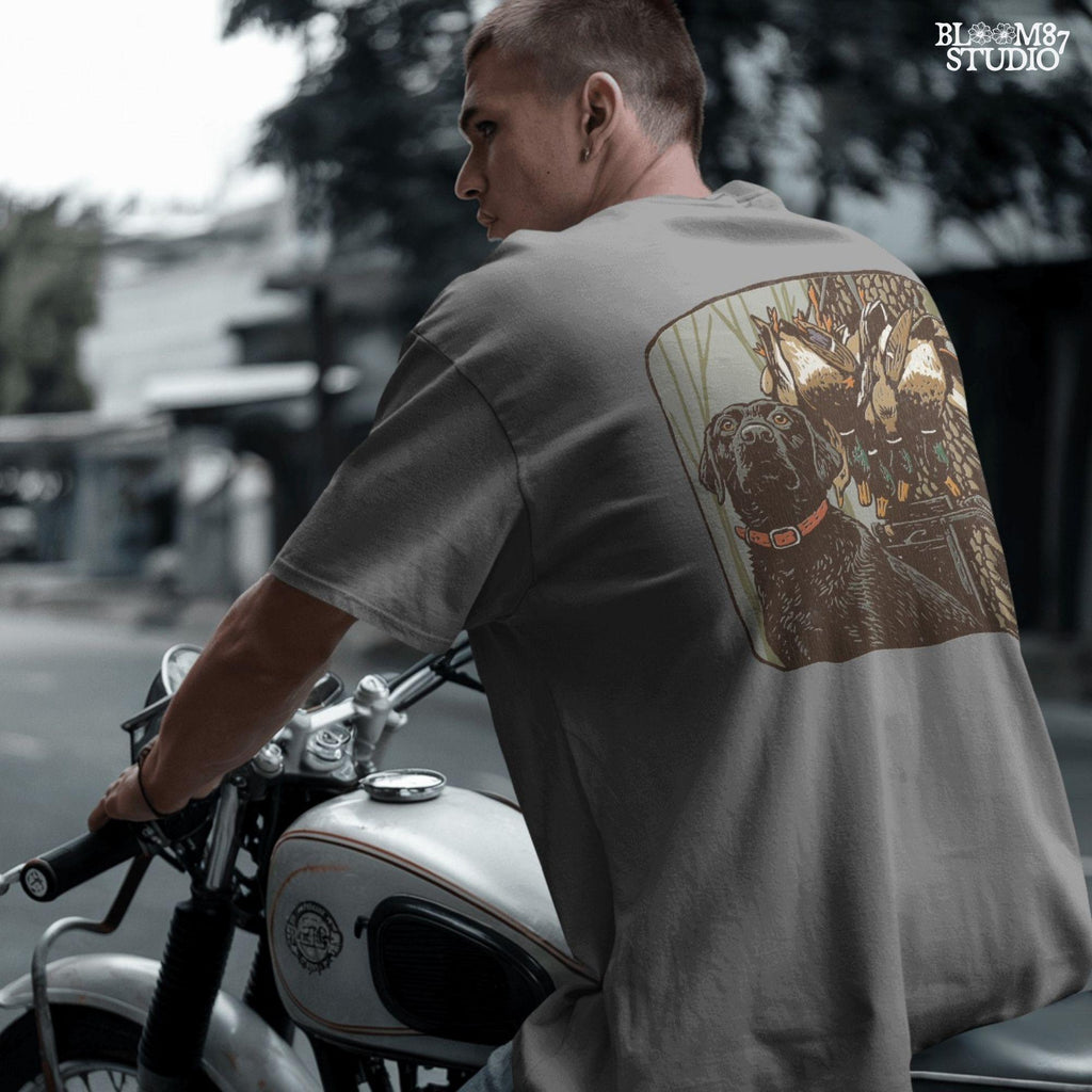 Digital PNG design of a black lab hunting dog with mallard ducks on a strap, ideal for sublimation printing on hunting-themed apparel