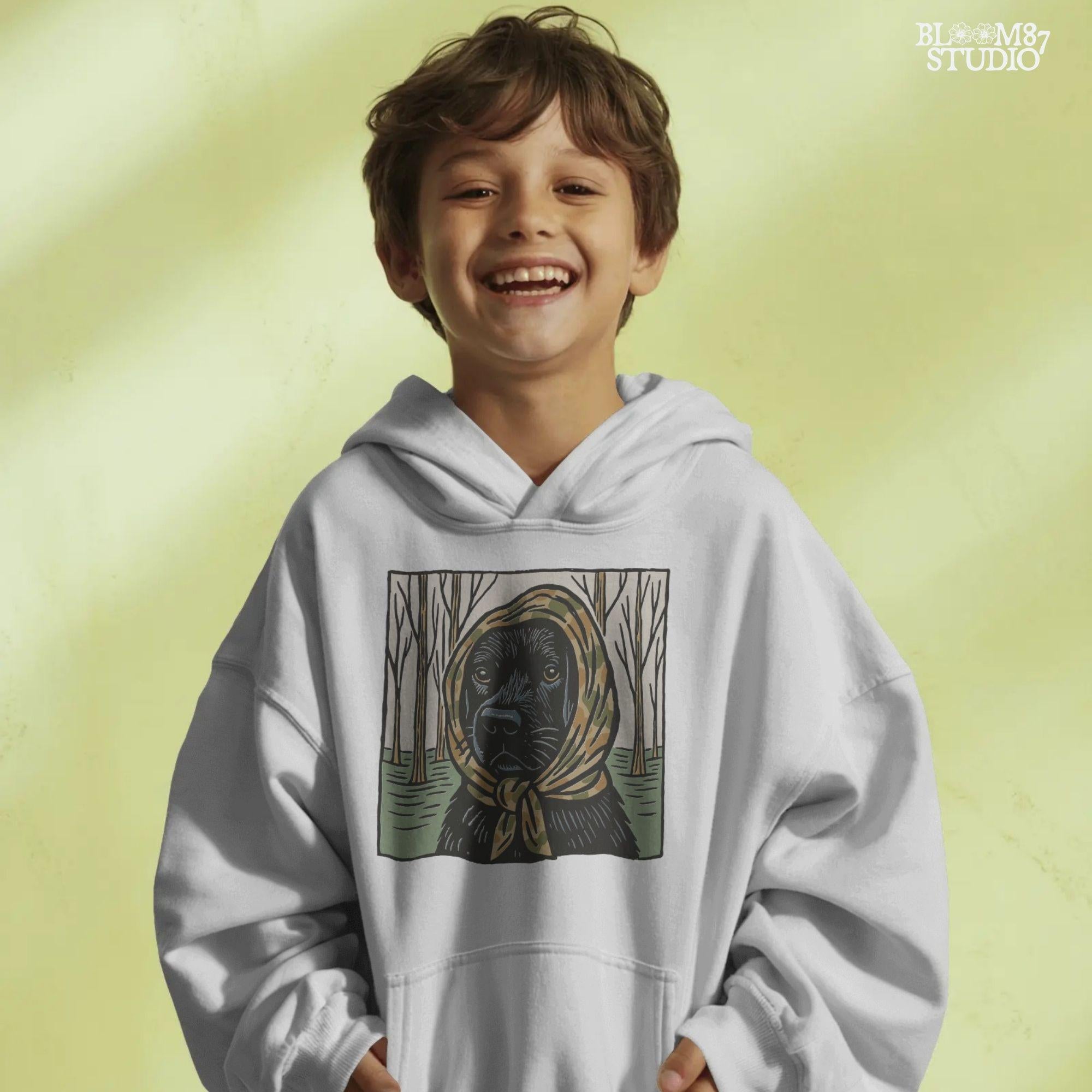 Digital PNG of a black labrador dog wearing a camo scarf in a forest setting, designed for hunting-themed sublimation printing