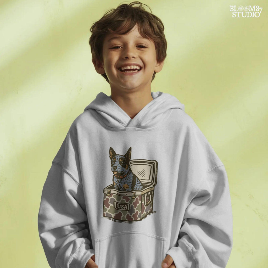 Blue Heeler Australian Cattle Dog sitting in USA camouflage ice chest cooler, patriotic digital PNG for sublimation designs.