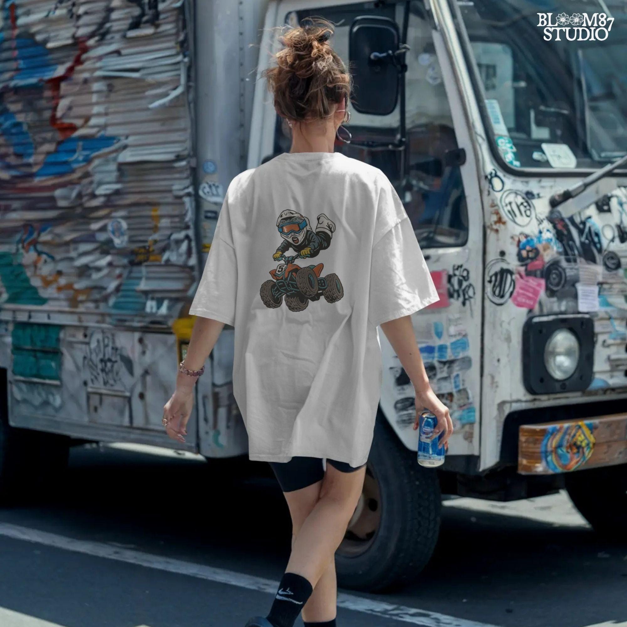 Digital PNG of a boy riding an ATV mid-jump wearing motocross gear and helmet, perfect for kids racing sublimation projects.