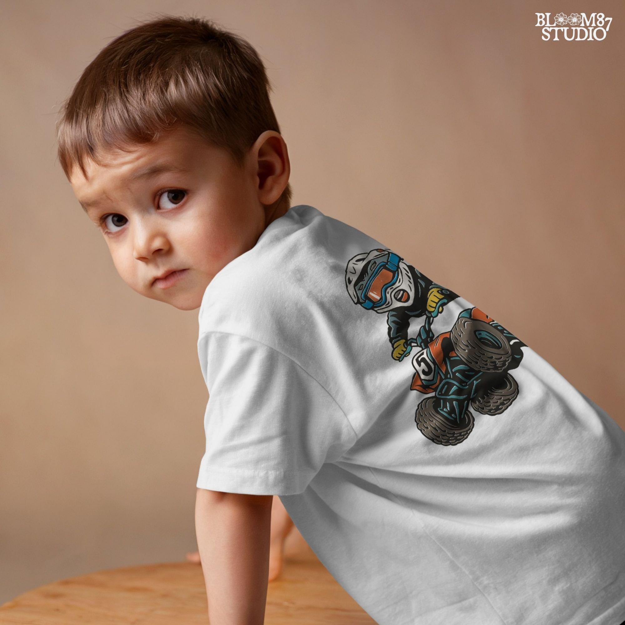 Digital PNG of a boy riding an ATV mid-jump wearing motocross gear and helmet, perfect for kids racing sublimation projects.