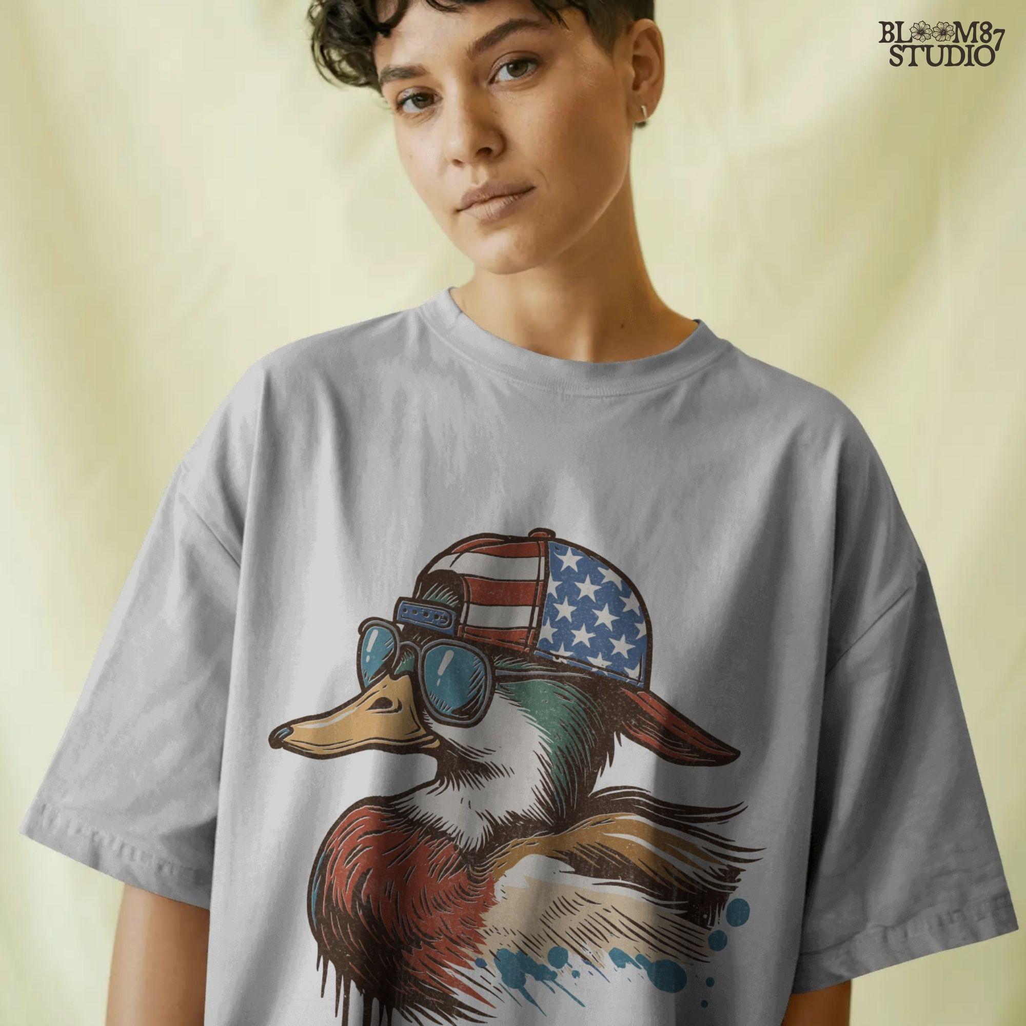 Cartoon mallard duck wearing American flag hat and sunglasses in a humorous patriotic style, with bold colors and splash detail