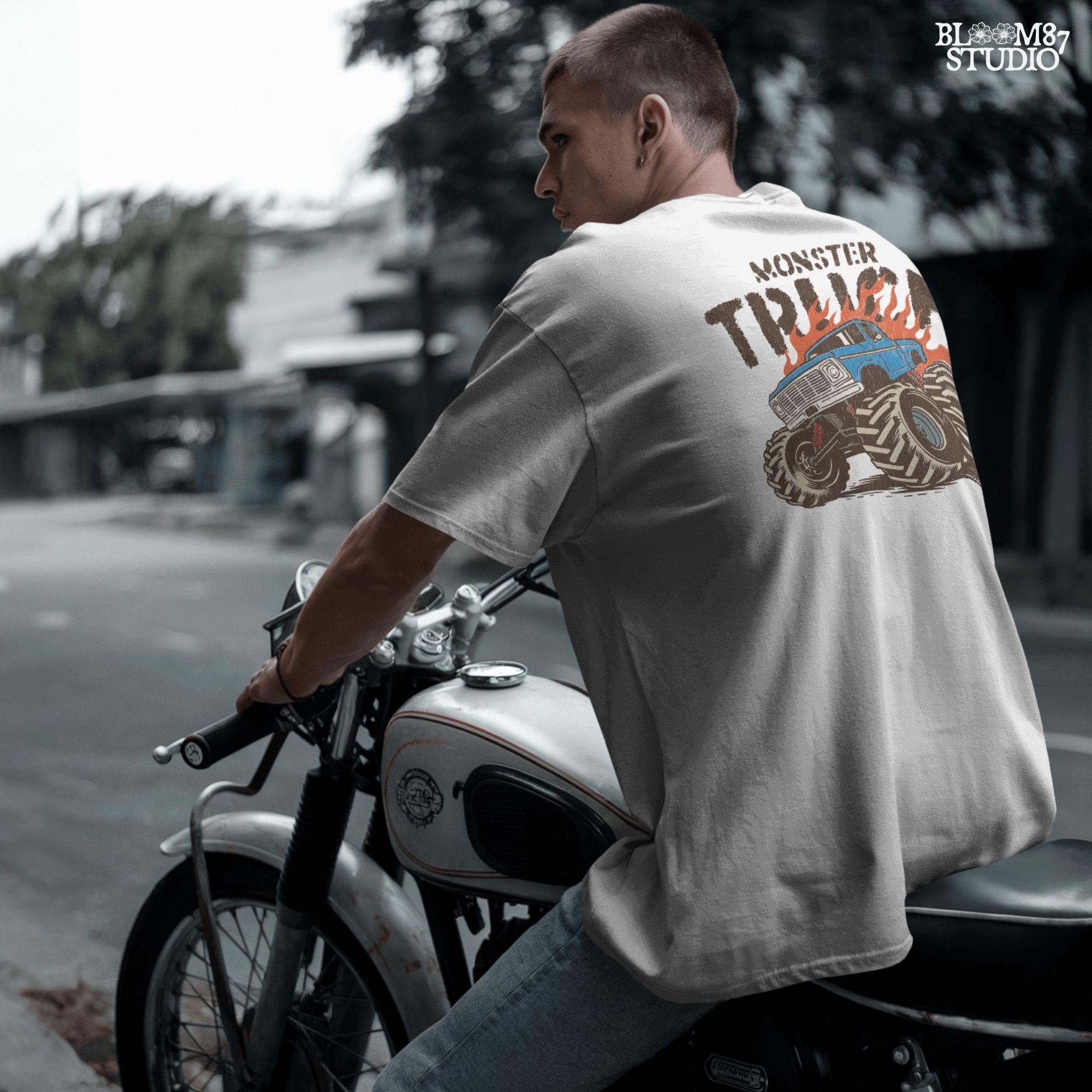 Blue monster truck with huge wheels and orange flames, illustrated in bold lines, ideal for boys birthday sublimation and crafts.