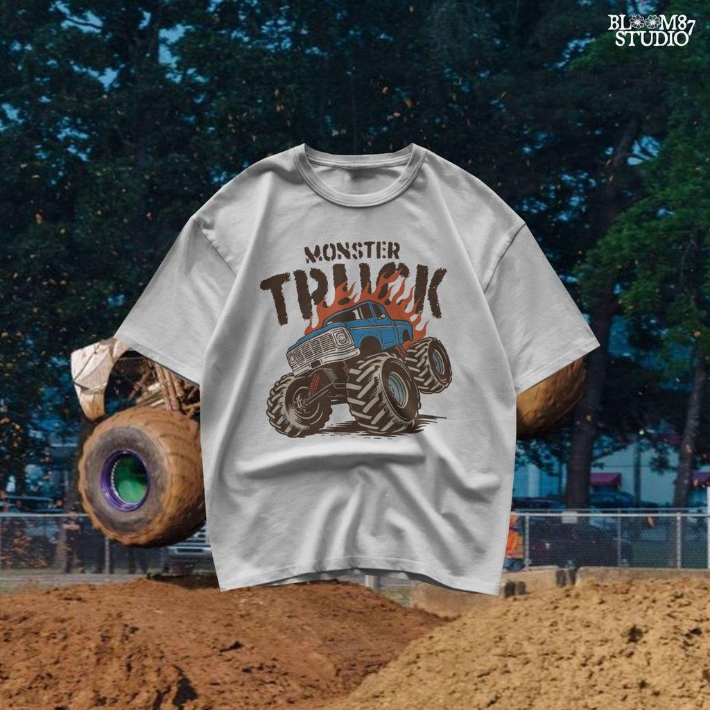 Blue monster truck with huge wheels and orange flames, illustrated in bold lines, ideal for boys birthday sublimation and crafts.