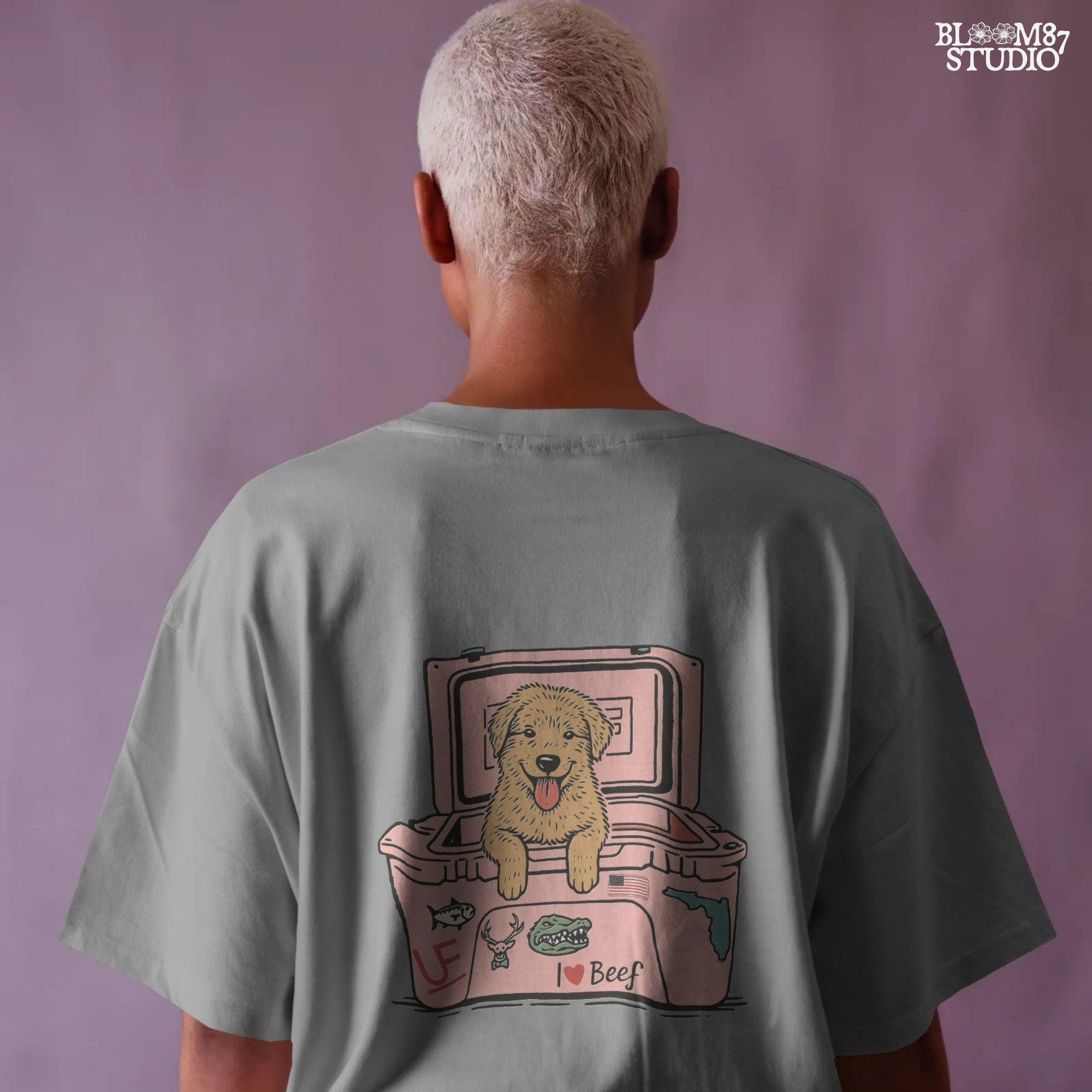 Golden retriever puppy with tongue out sitting inside a pink cooler decorated with Florida and beef stickers, sublimation design for dog lovers.