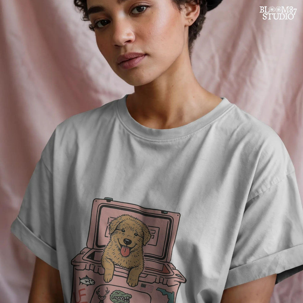 Golden retriever puppy with tongue out sitting inside a pink cooler decorated with Florida and beef stickers, sublimation design for dog lovers.