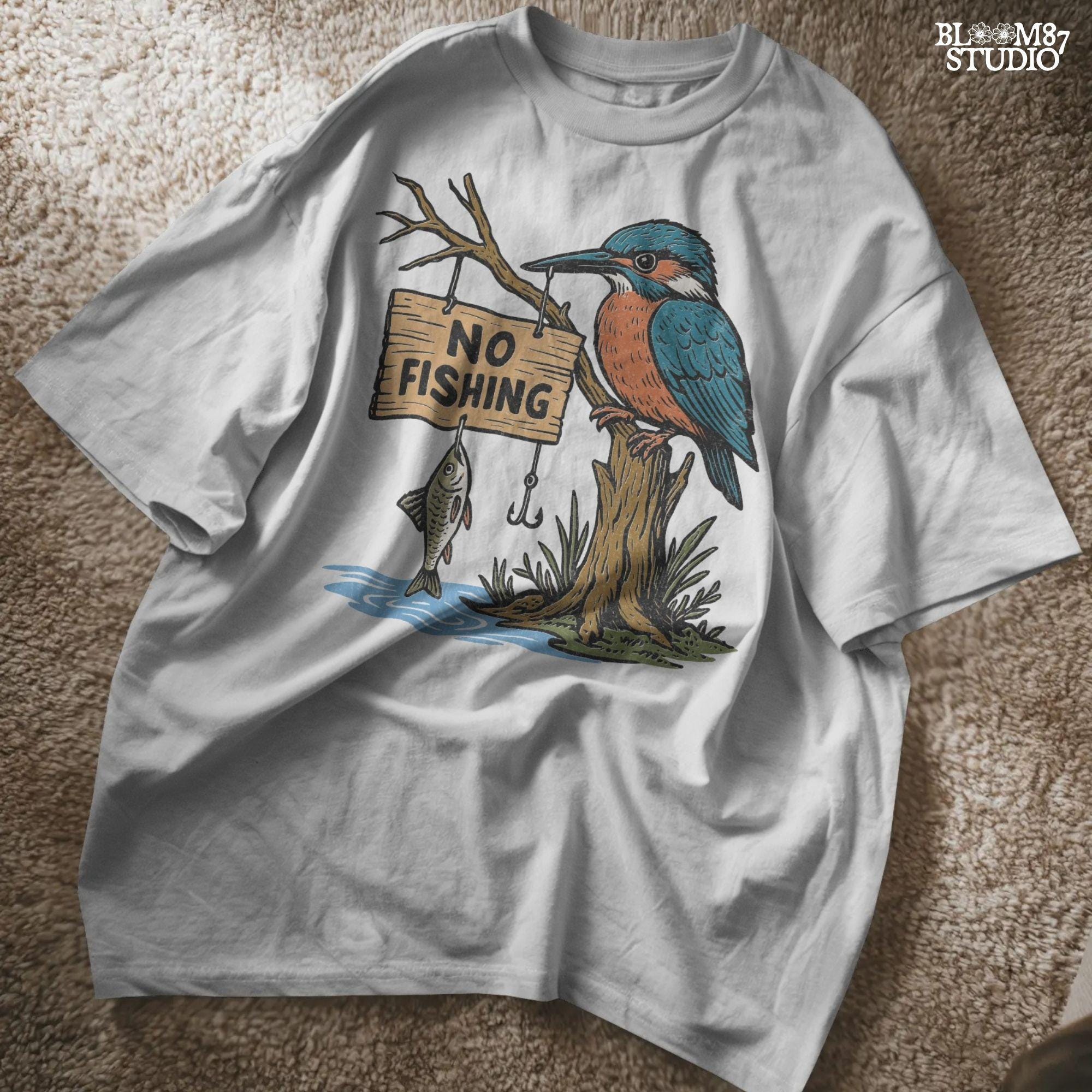 Cartoon kingfisher bird sitting on a tree holding a “No Fishing” sign with a fish hanging below, in a humorous lake life design