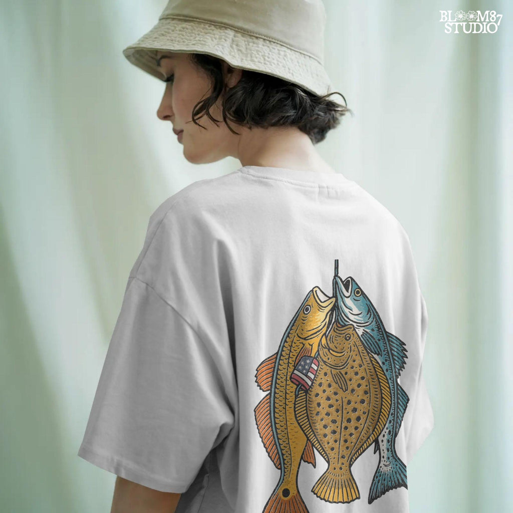 Three saltwater game fish (redfish, flounder, trout) hanging from a line, with a small American flag detail on one fish, in vintage patriotic fishing style