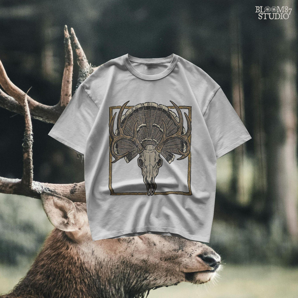 Illustration of a deer skull with antlers set in front of a fanned turkey tail and framed in a rustic square border