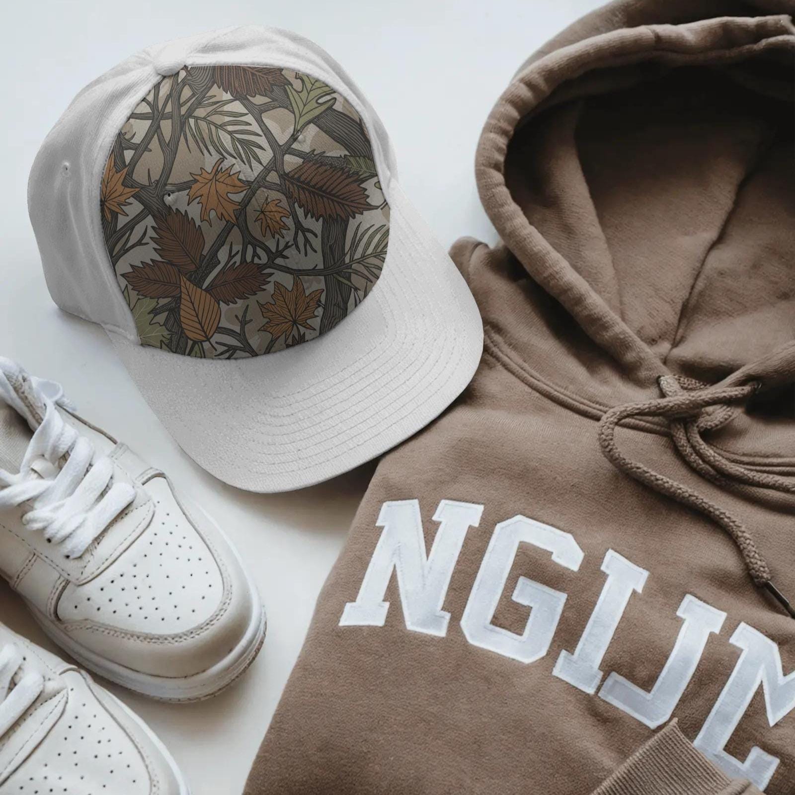 Seamless camouflage PNG pattern with autumn leaves, tree branches, and earthy tones of orange, brown, and green for fall sublimation use.