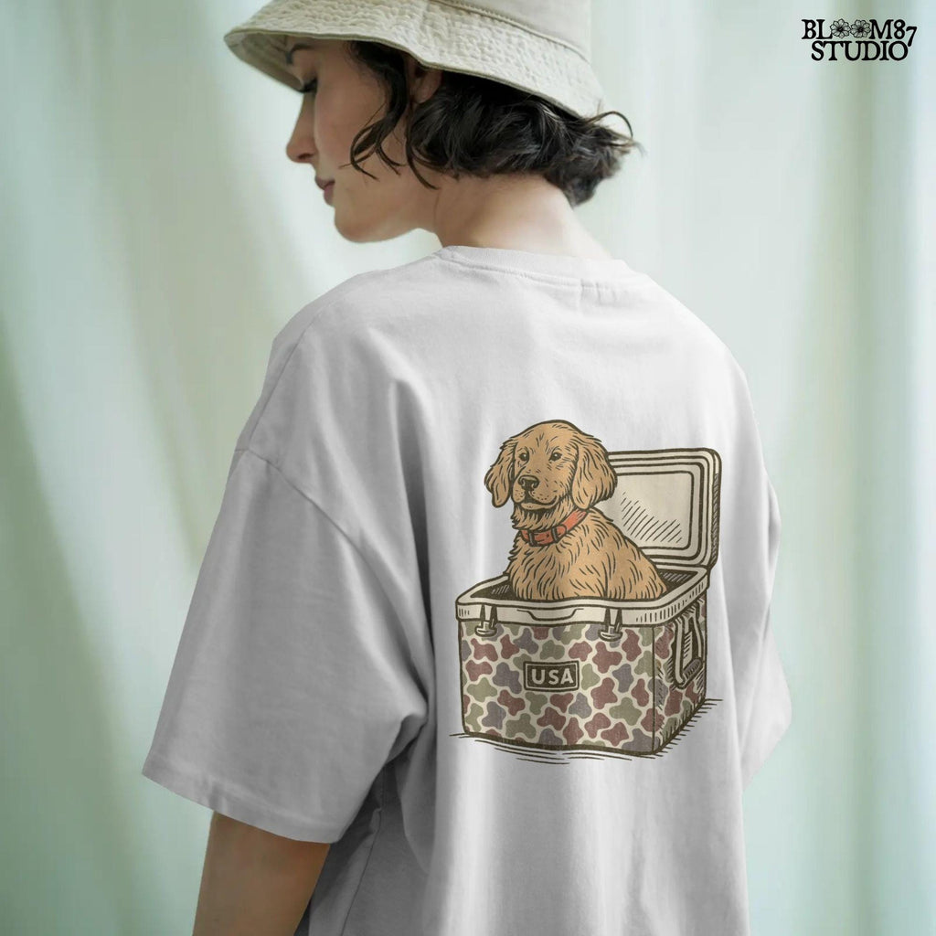 Cute golden retriever dog sitting inside a camouflage cooler with “USA” label, in a rustic patriotic cartoon style