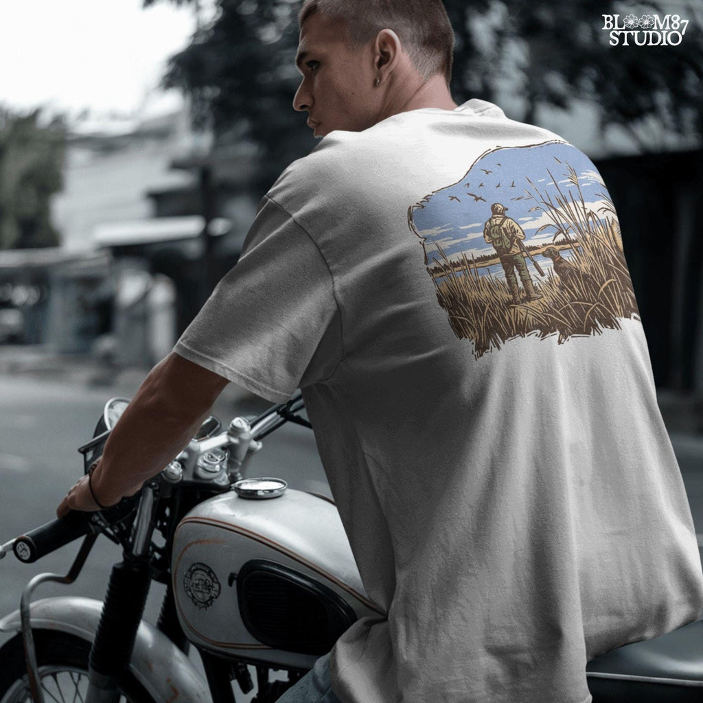 Rustic illustration of a duck hunter with shotgun standing beside his dog in a marsh, watching ducks fly overhead under a blue sky