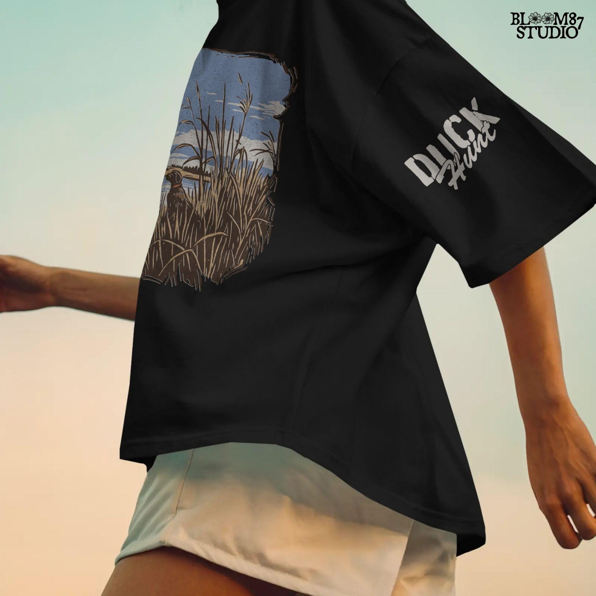 Rustic illustration of a duck hunter with shotgun standing beside his dog in a marsh, watching ducks fly overhead under a blue sky