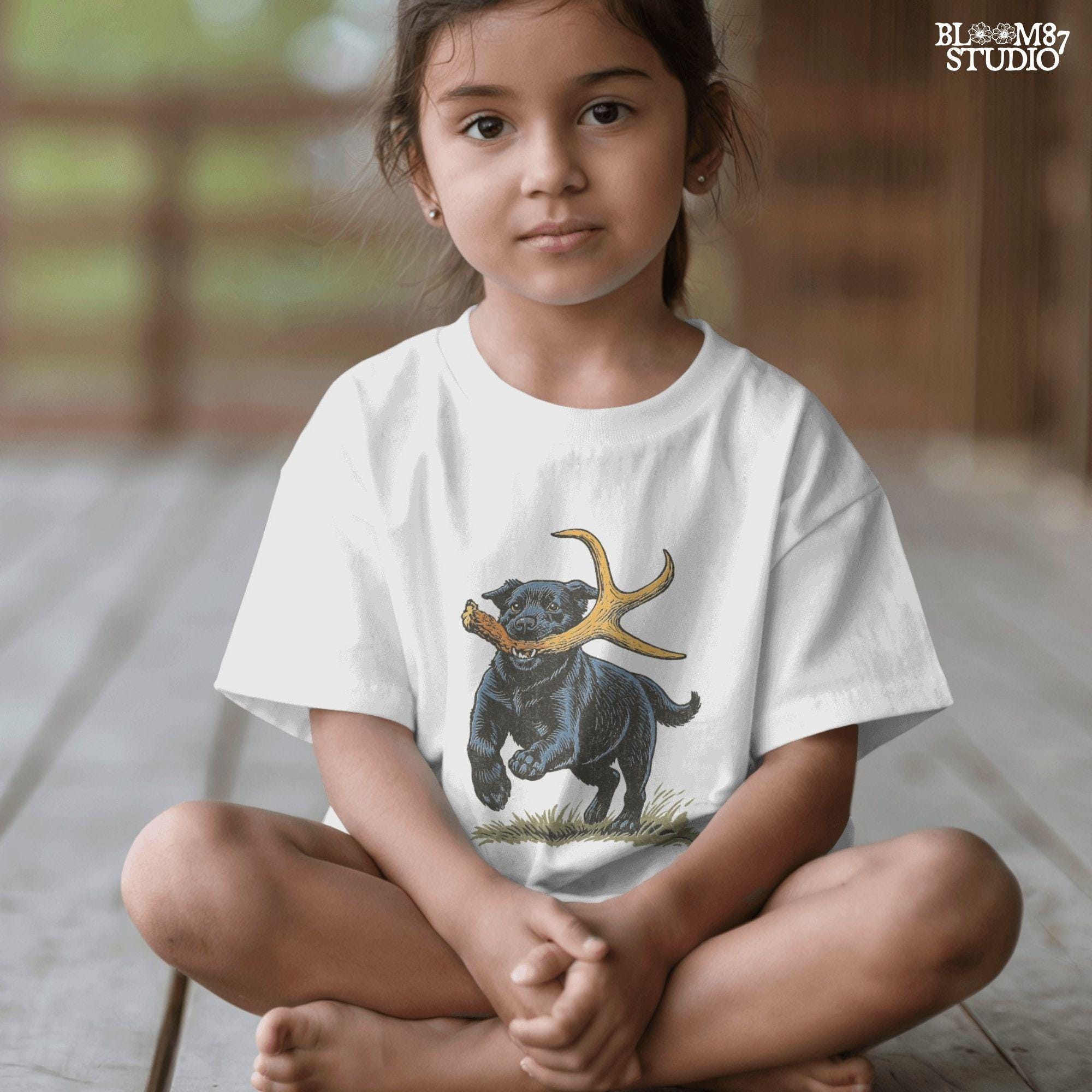 Black Labrador retriever running with a deer shed antler in its mouth, with bonus “Shed Hunt” circular pocket badge in rustic style