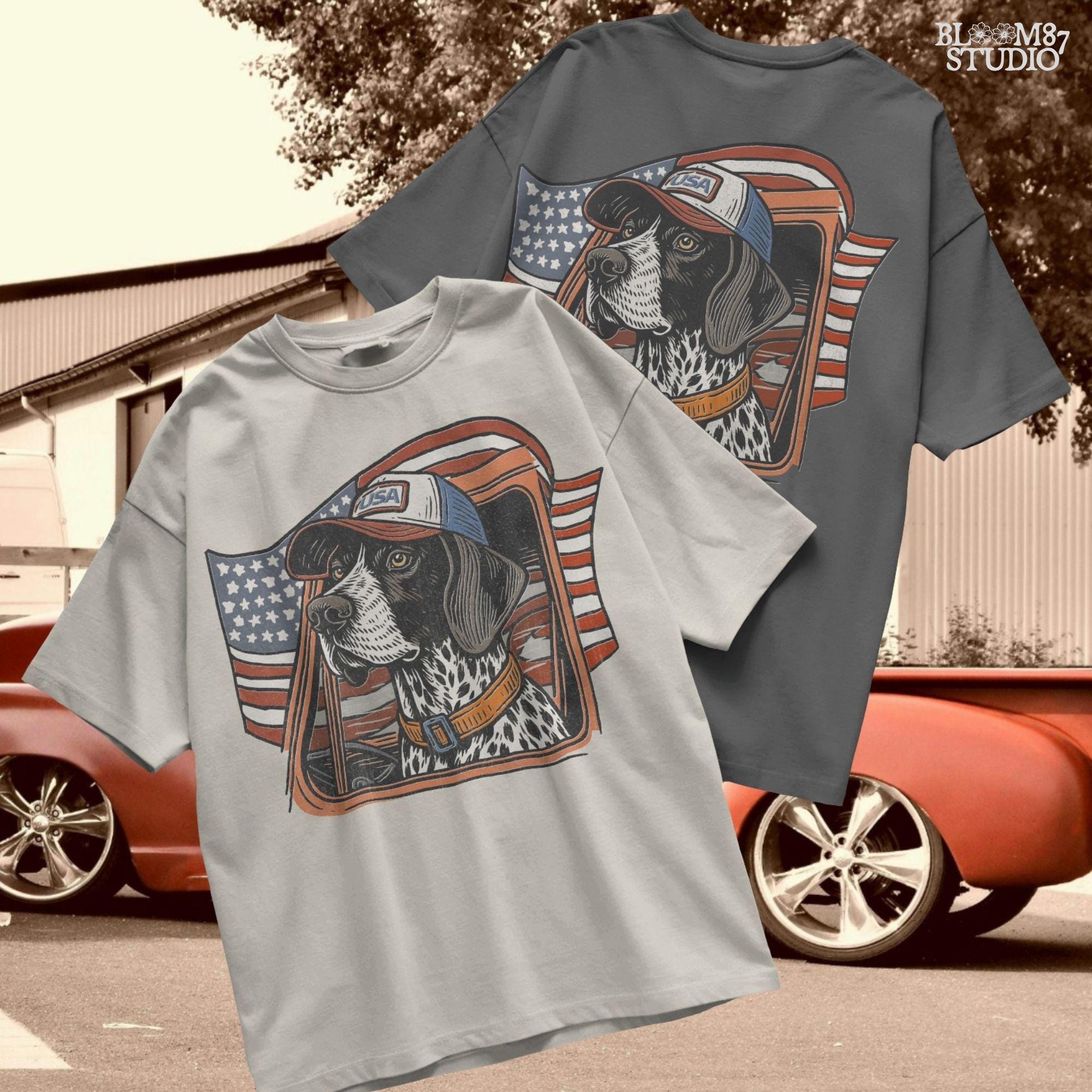 German Shorthaired Pointer dog wearing USA hat looking out of truck window with American flag waving in background