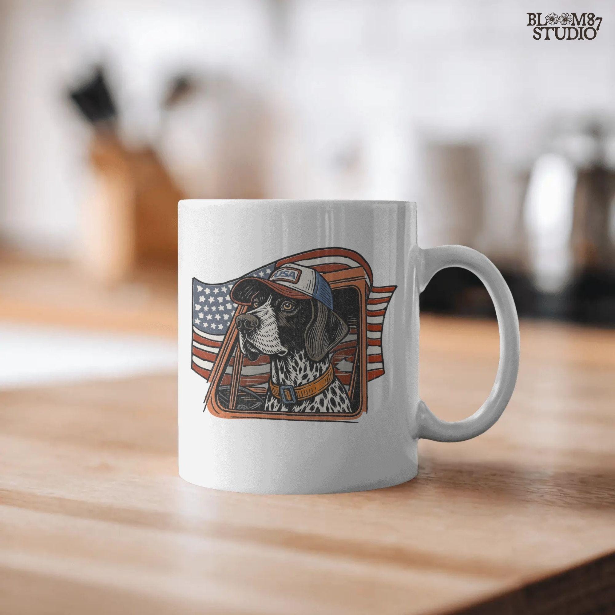 German Shorthaired Pointer dog wearing USA hat looking out of truck window with American flag waving in background