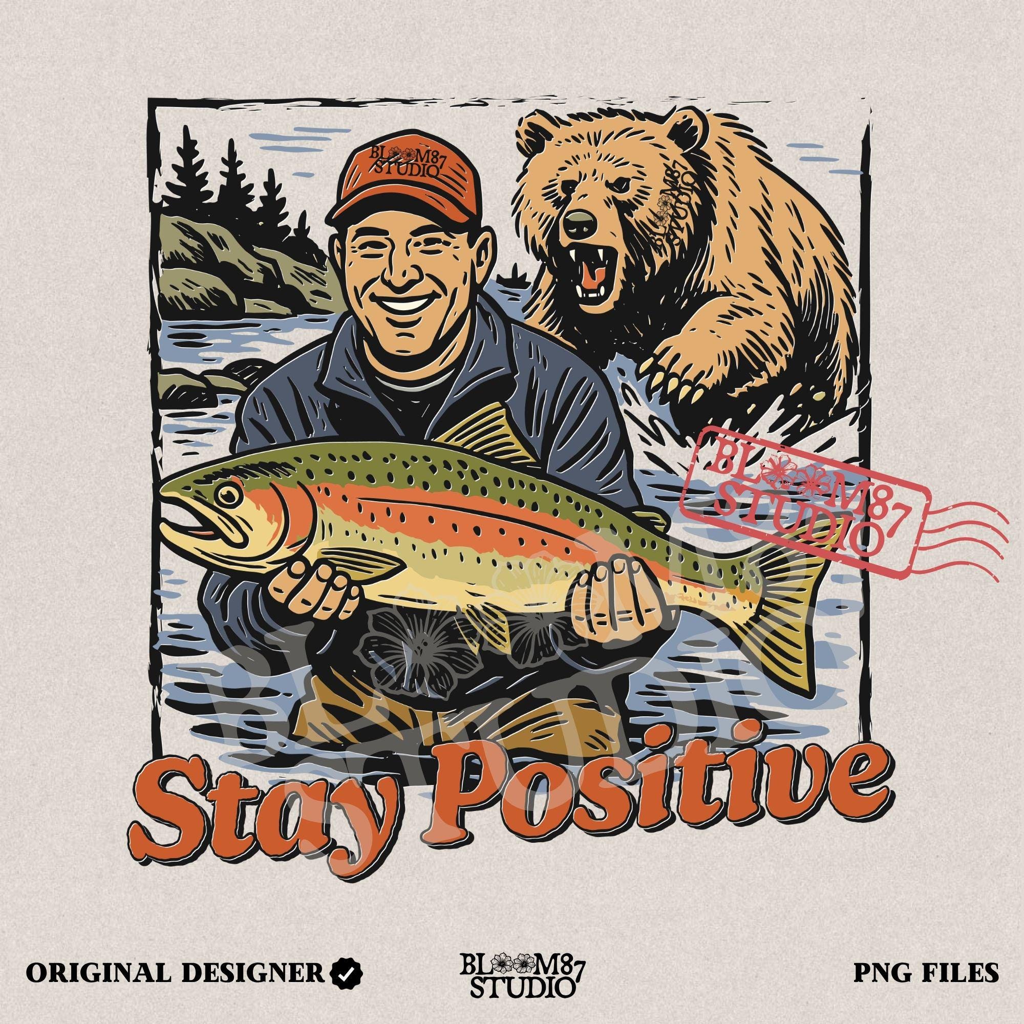Happy fisherman holding large trout in river while a grizzly bear charges from behind, with text “Stay Positive” in funny outdoor design style