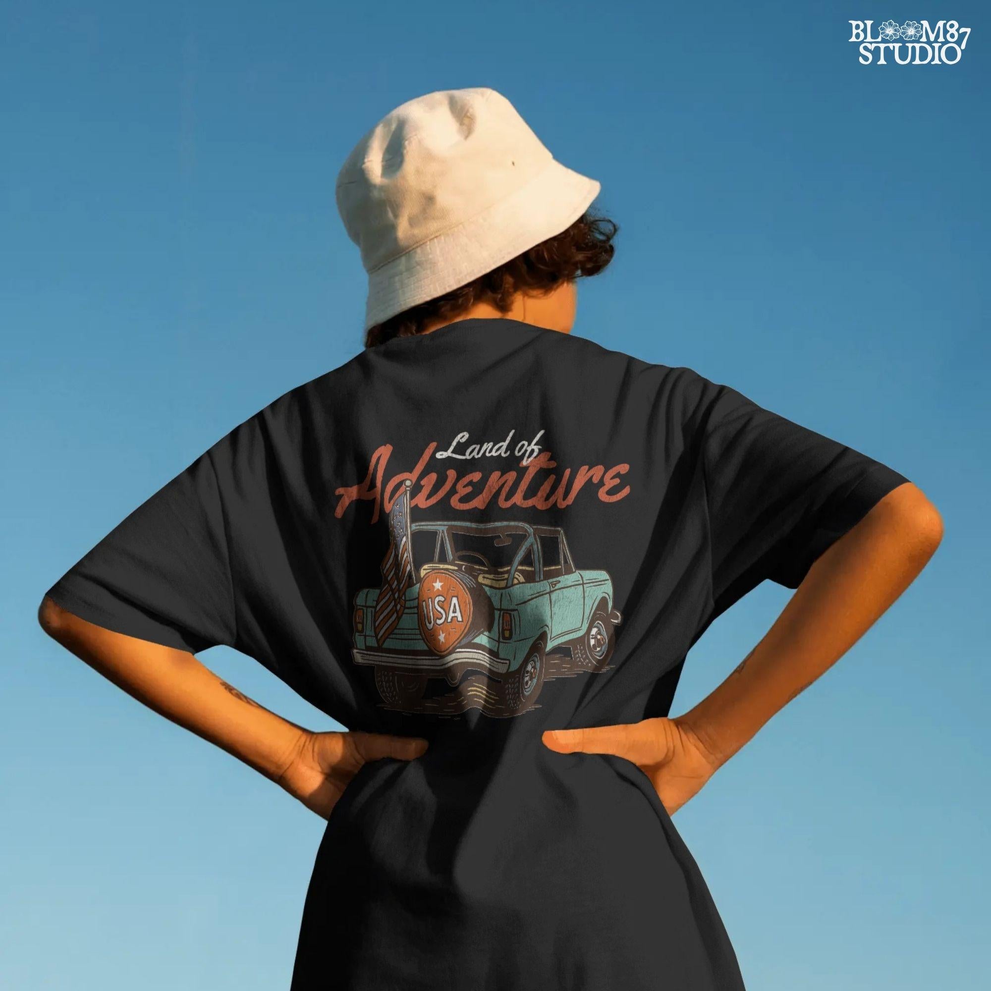 Vintage convertible truck with “USA” spare tire and American flag, text reads “Land of Adventure,” in a retro patriotic illustration style.