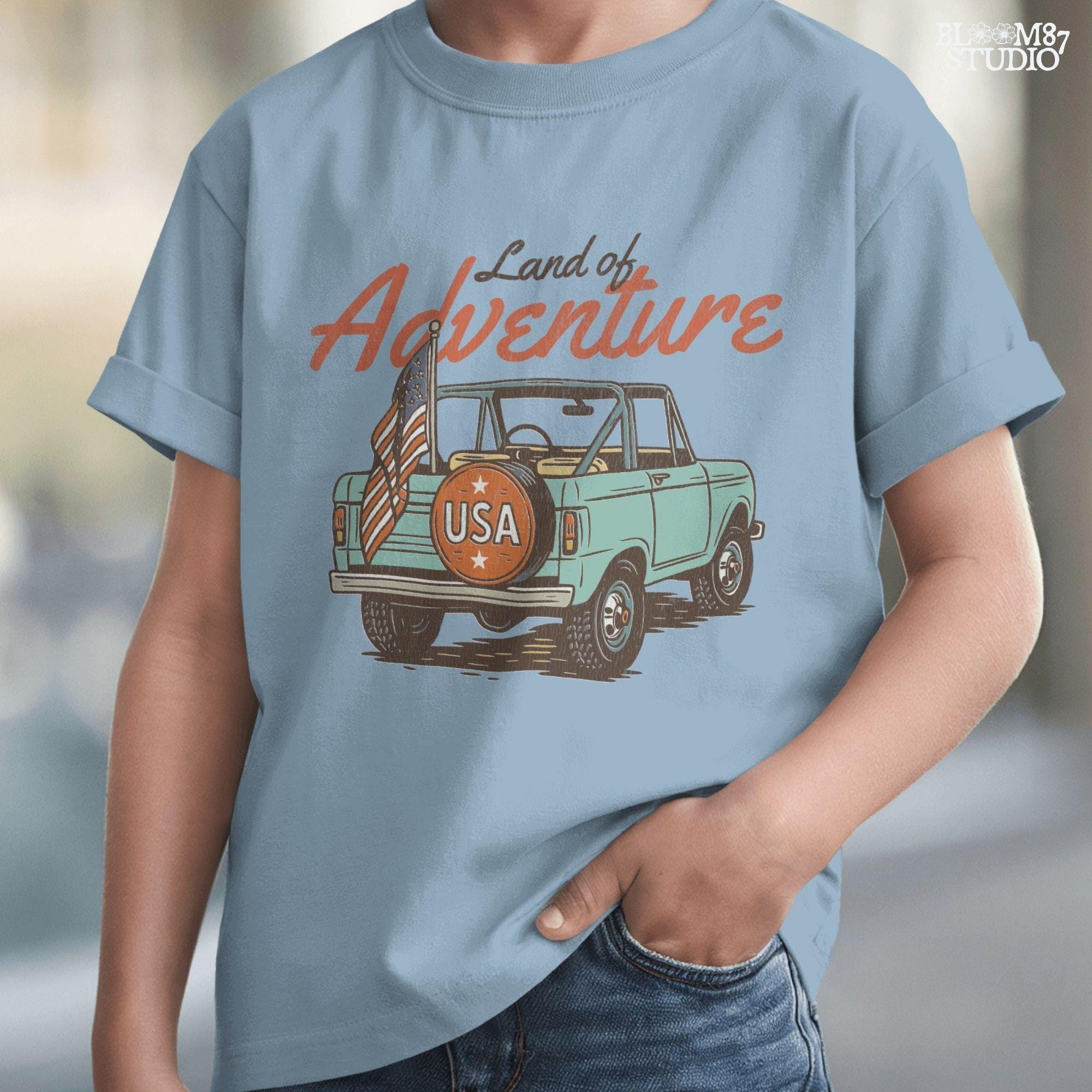 Vintage convertible truck with “USA” spare tire and American flag, text reads “Land of Adventure,” in a retro patriotic illustration style.