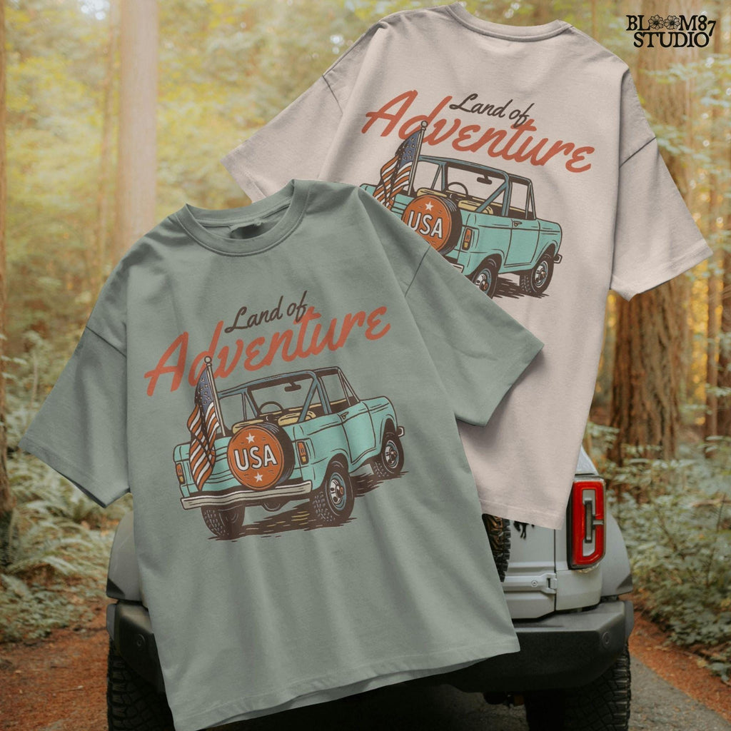 Vintage convertible truck with “USA” spare tire and American flag, text reads “Land of Adventure,” in a retro patriotic illustration style.