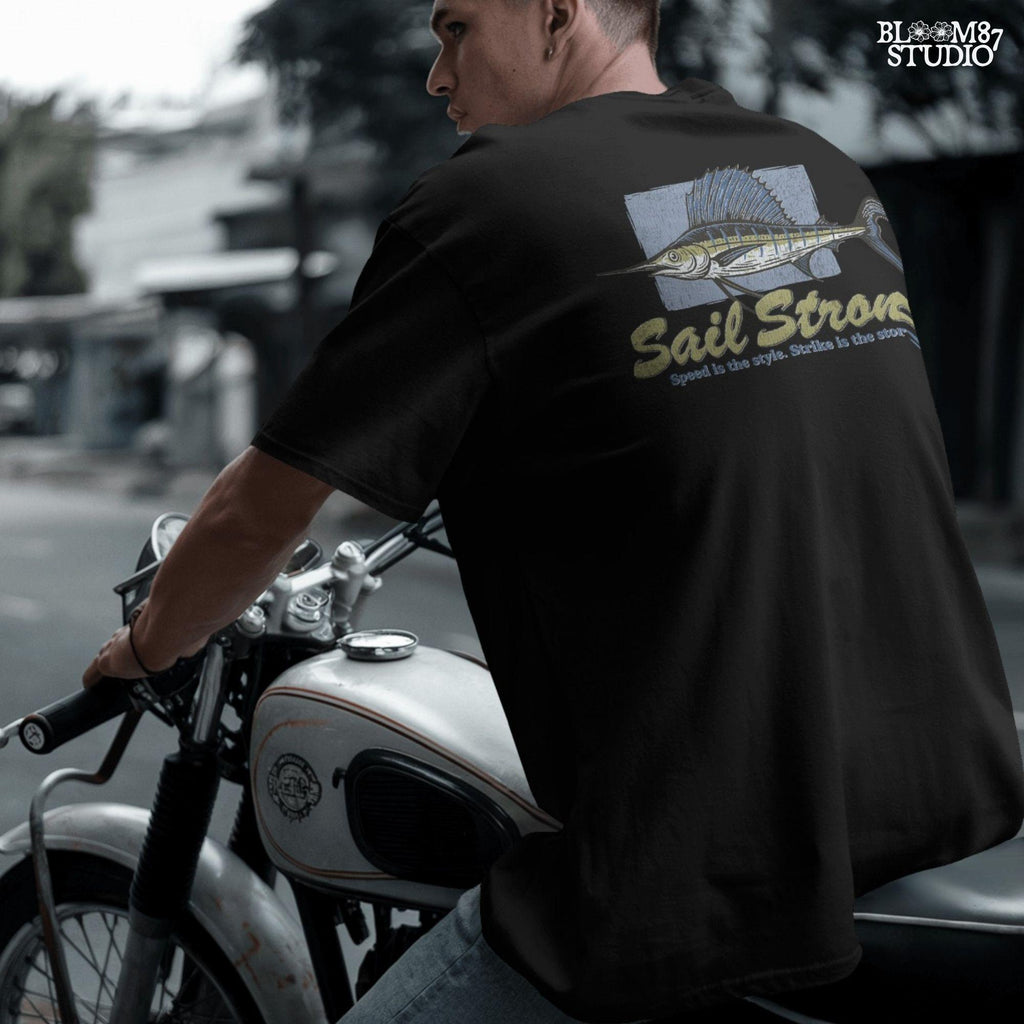 Illustrated sailfish with bold dorsal fin and text “Sail Strong – Speed is the style. Strike is the story” in nautical, vintage style.