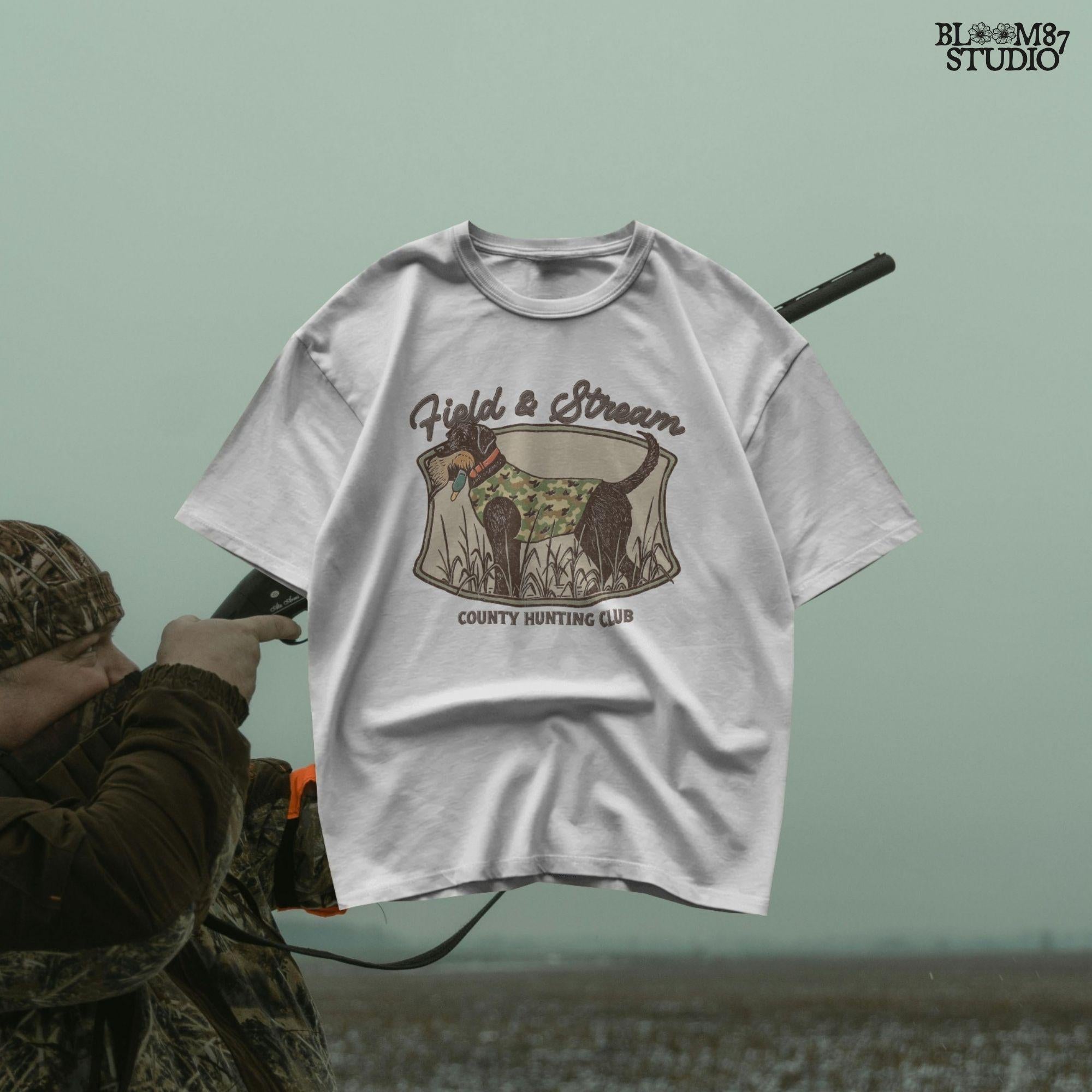 Vintage-style hunting club patch design featuring a black labrador in camo with a duck in its mouth, and the text “Field & Stream – County Hunting Club,” ideal for sublimation.
