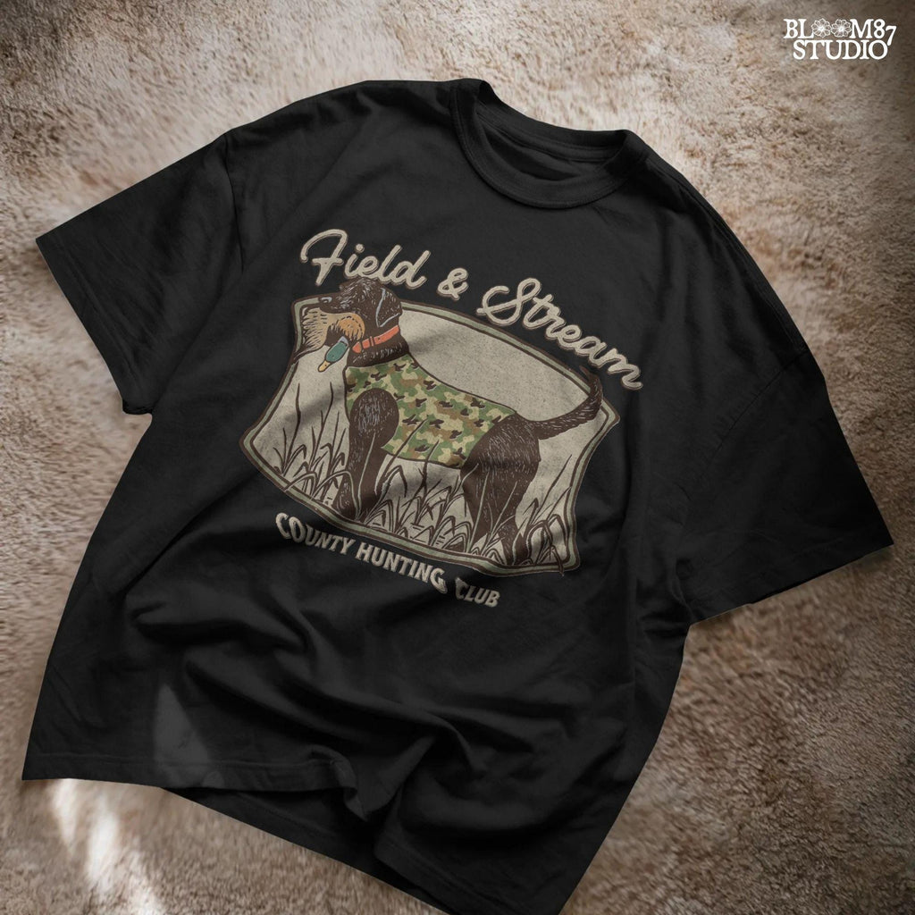 Vintage-style hunting club patch design featuring a black labrador in camo with a duck in its mouth, and the text “Field & Stream – County Hunting Club,” ideal for sublimation.