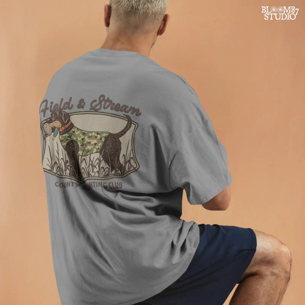 Vintage-style hunting club patch design featuring a black labrador in camo with a duck in its mouth, and the text “Field & Stream – County Hunting Club,” ideal for sublimation.