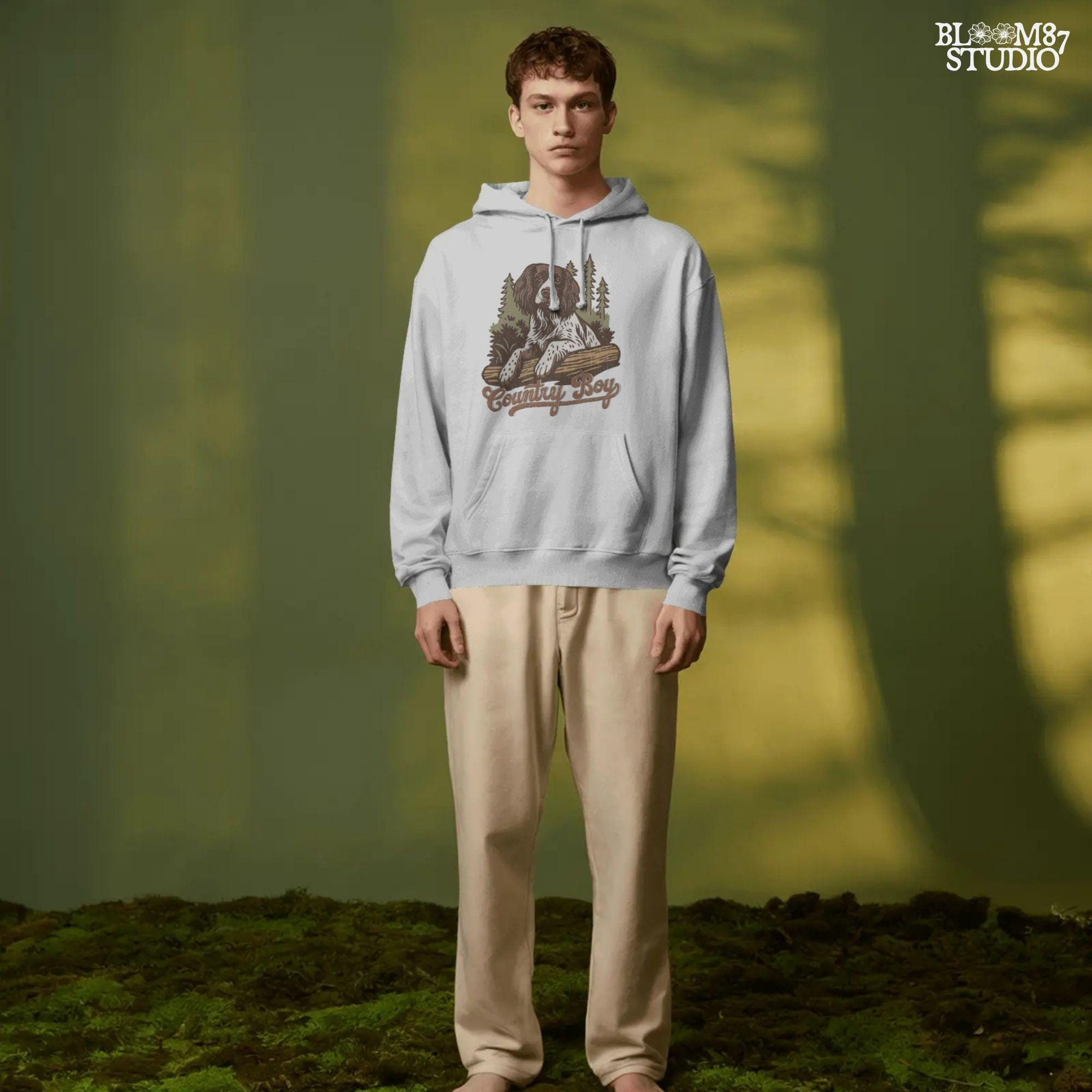 Illustration of a Springer Spaniel dog laying on a log in the woods with the words “Country Boy,” designed for rustic-themed sublimation and hunting dog lovers.