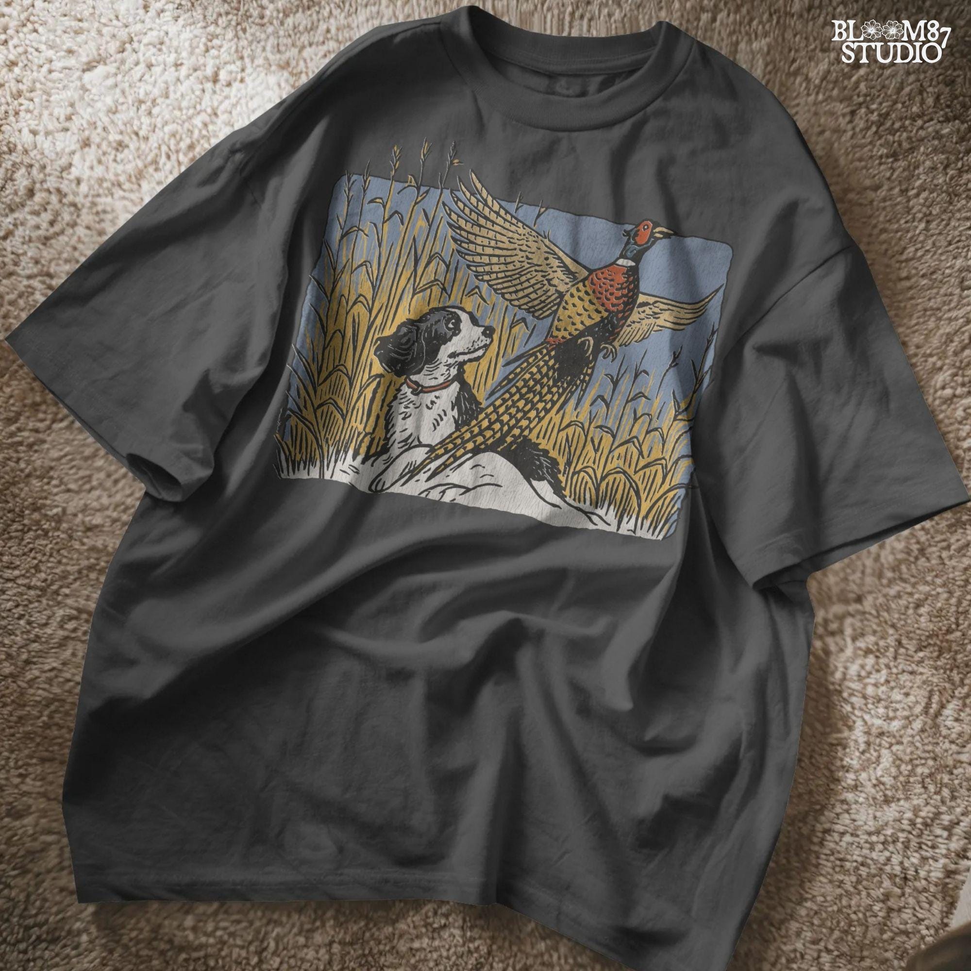 Vintage-style illustration of a black and white hunting dog watching a colorful pheasant take flight in a cornfield, designed for rustic outdoor themes.