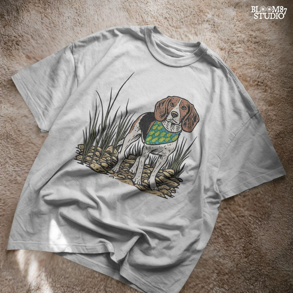Hand-drawn beagle dog wearing a pineapple bandana, standing in a rocky grass field, designed for sublimation and pet lover gifts.