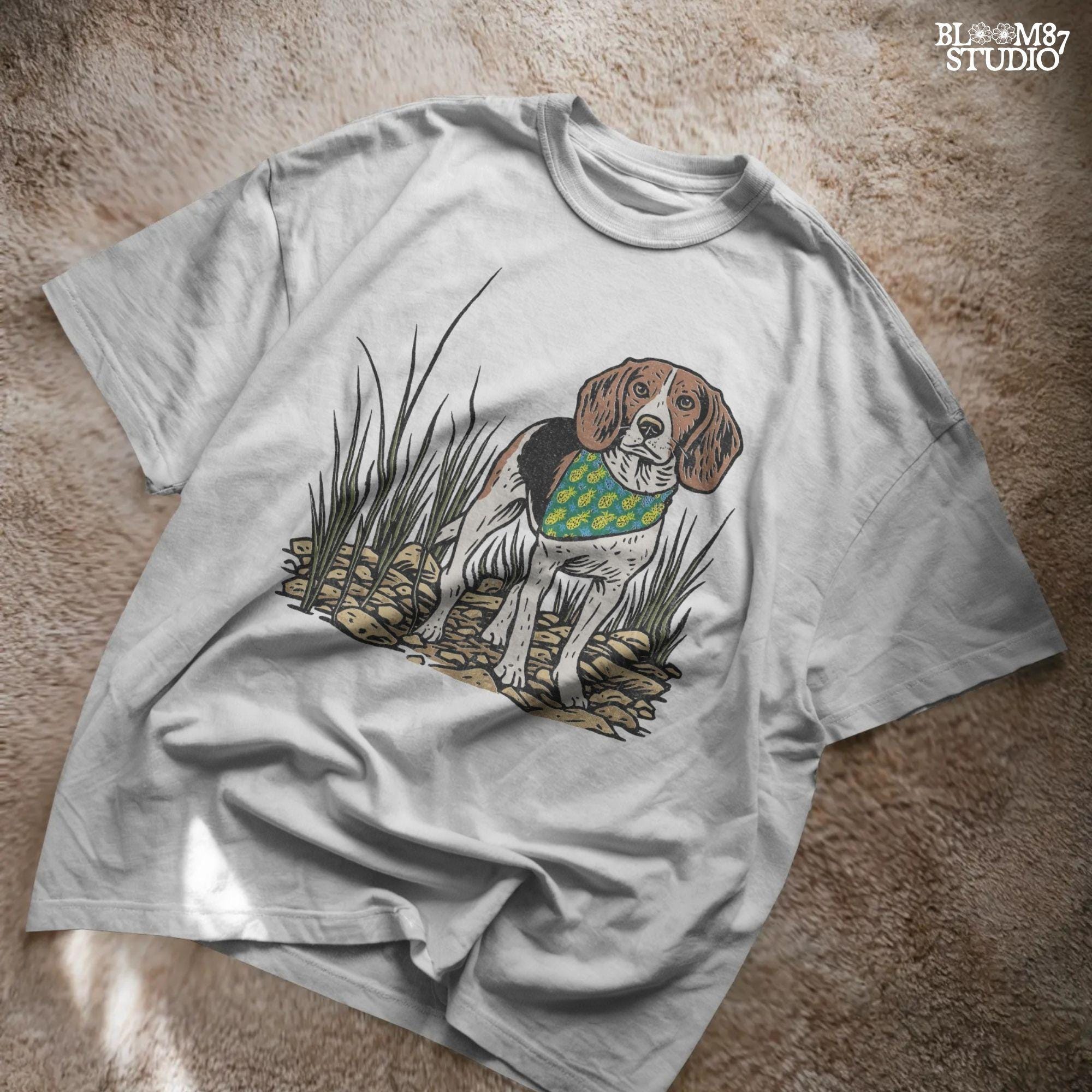 Hand-drawn beagle dog wearing a pineapple bandana, standing in a rocky grass field, designed for sublimation and pet lover gifts.
