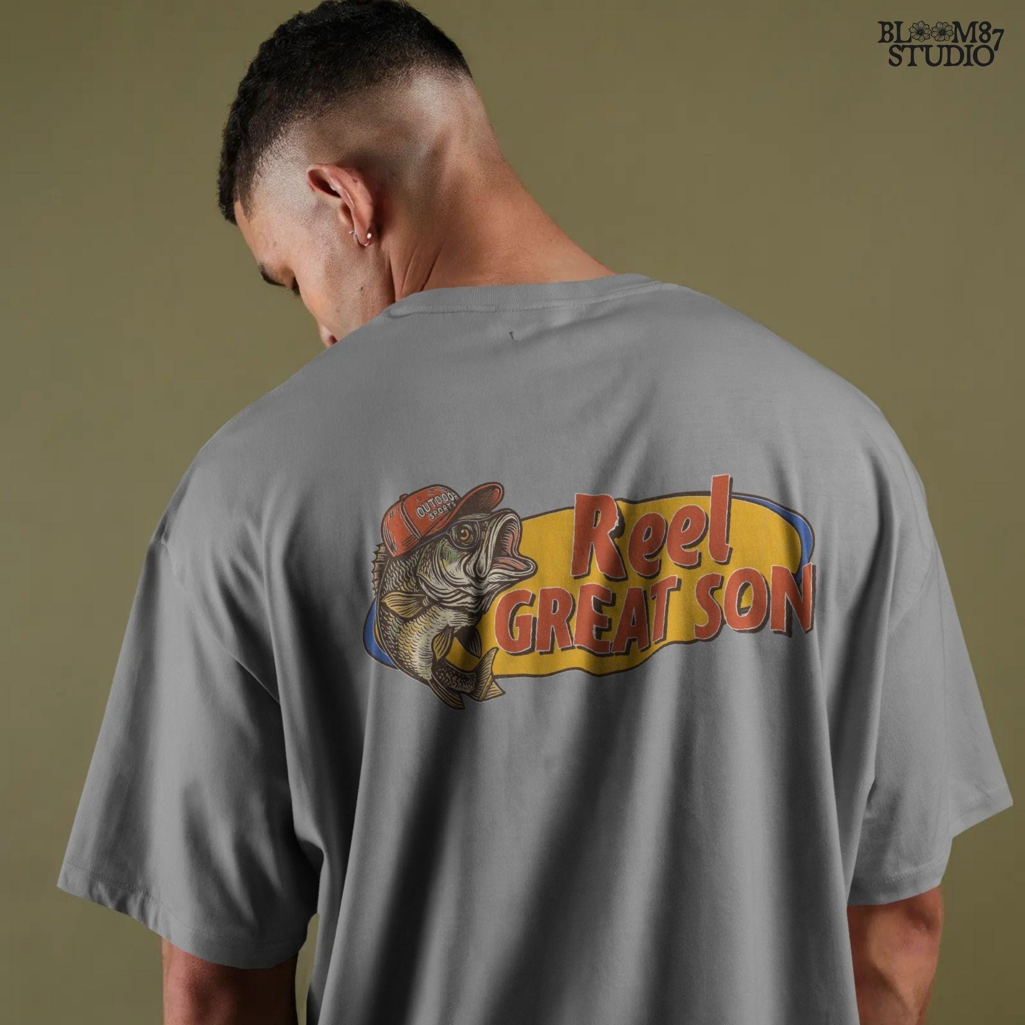 Illustration of a bass fish wearing a red trucker hat with the text “Reel Great Son” in bold vintage lettering, designed for sublimation and fishing-themed gifts for kids.