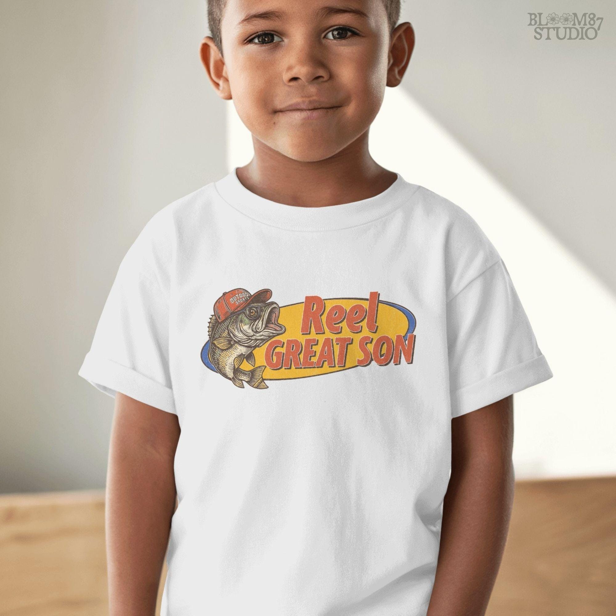 Illustration of a bass fish wearing a red trucker hat with the text “Reel Great Son” in bold vintage lettering, designed for sublimation and fishing-themed gifts for kids.