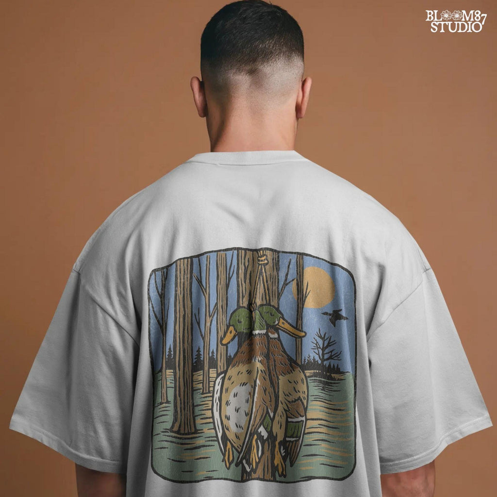 Illustration of two mallard ducks hanging from a tree in a flooded timber swamp at sunset, designed for duck hunting-themed sublimation and lodge decor.