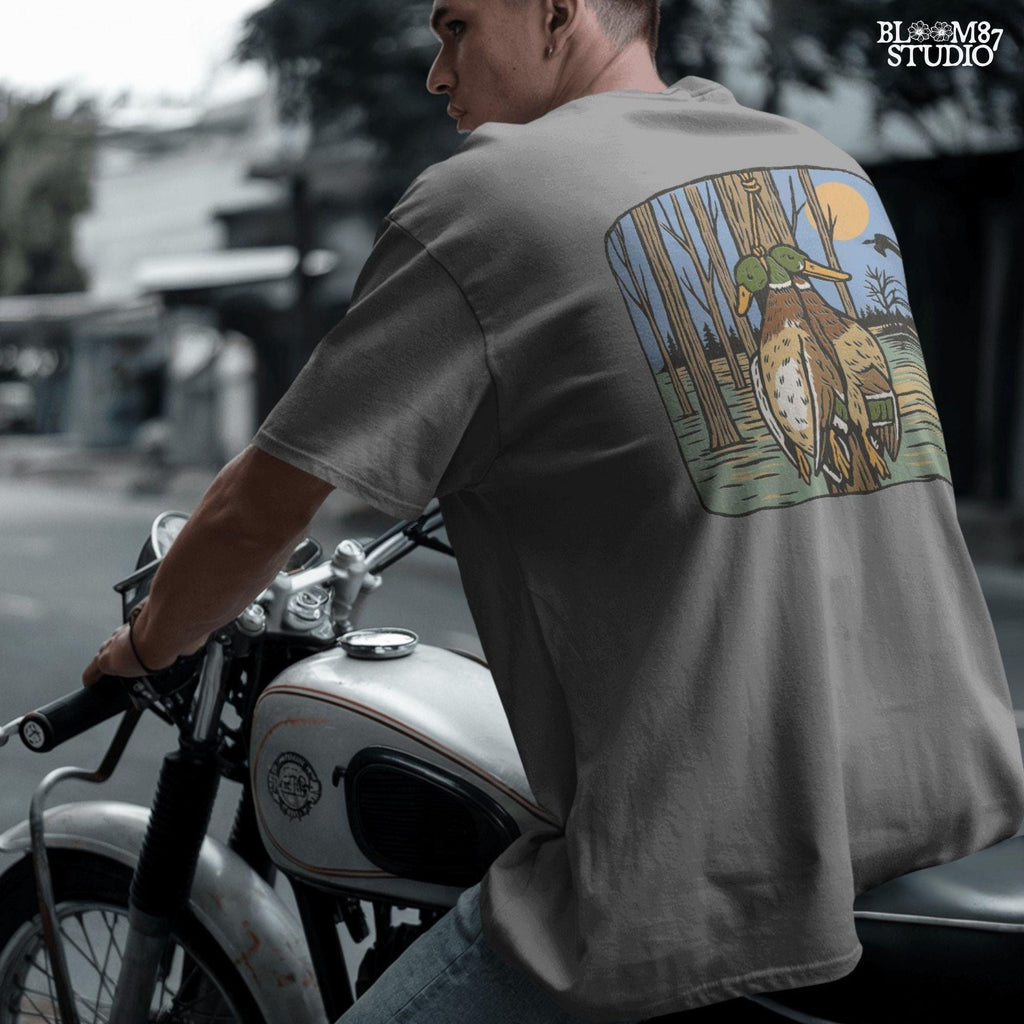 Illustration of two mallard ducks hanging from a tree in a flooded timber swamp at sunset, designed for duck hunting-themed sublimation and lodge decor.