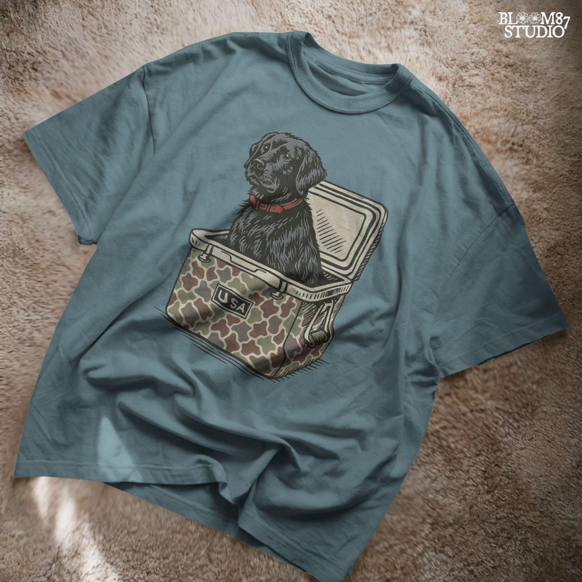 Hand-drawn black Labrador retriever sitting in a camouflage cooler labeled “USA,” designed for sublimation and hunting-themed merchandise.