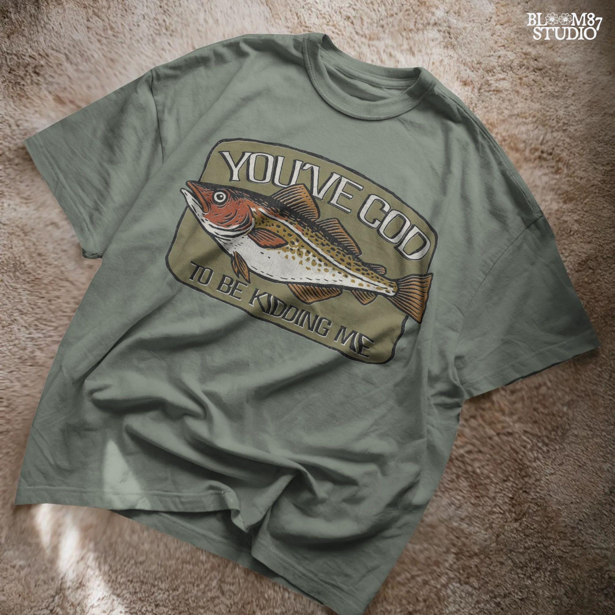 Hand-drawn Atlantic cod with the pun text “You’ve Cod to Be Kidding Me,” designed for funny fishing sublimation and dad joke gifts.