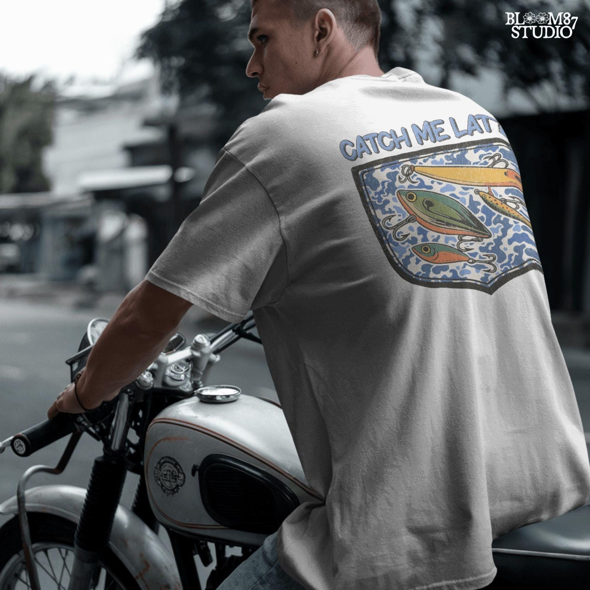 Funny “Catch Me Later” text above a faux blue camo pocket with colorful fishing lures, designed for sublimation printing on fisherman-themed apparel.