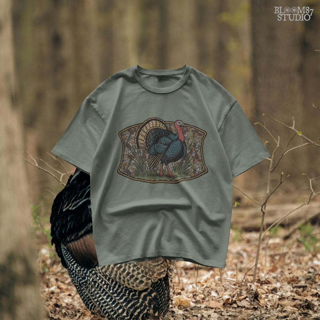 Illustration of a strutting wild turkey in front of a detailed fall camouflage background with brown and orange leaves, designed for sublimation on hunting shirts and Thanksgiving outdoor gear.
