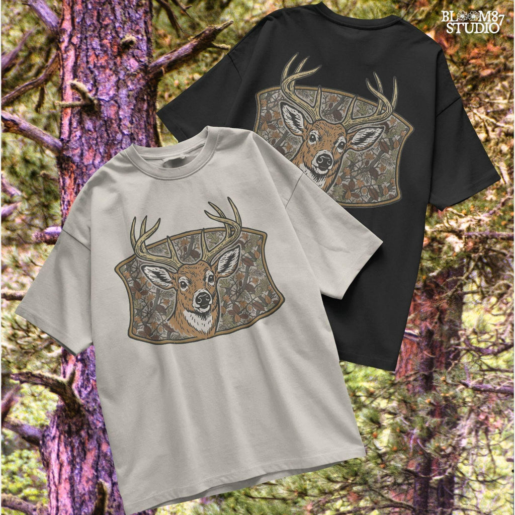 Illustration of a whitetail buck with large antlers in front of a fall forest camo background featuring leaves and branches, perfect for hunting-themed sublimation.