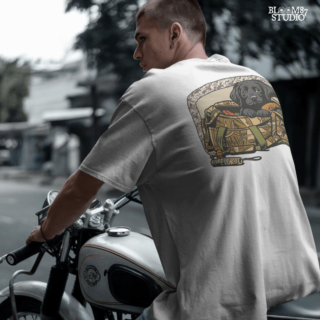 Black Labrador puppy in a camo hunting bag, framed in camouflage pattern, ideal for waterfowl and duck hunting sublimation art.