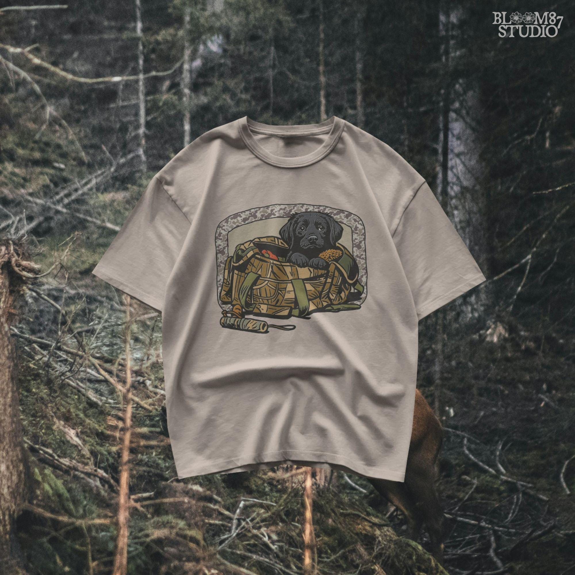 Black Labrador puppy in a camo hunting bag, framed in camouflage pattern, ideal for waterfowl and duck hunting sublimation art.